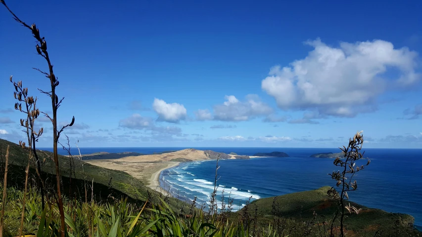 ocean and sky with a view to a hill