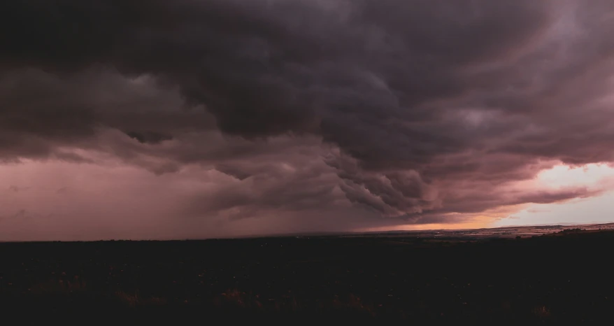 a sky with a lot of dark clouds above a plain