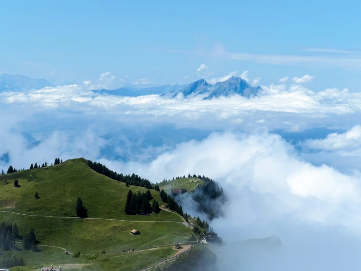 the view from the top of the mountain, shows clouds flying over the hills