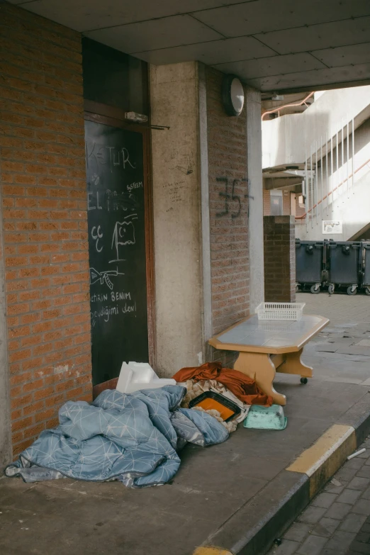 a pile of clothes and books are laying on a curb outside