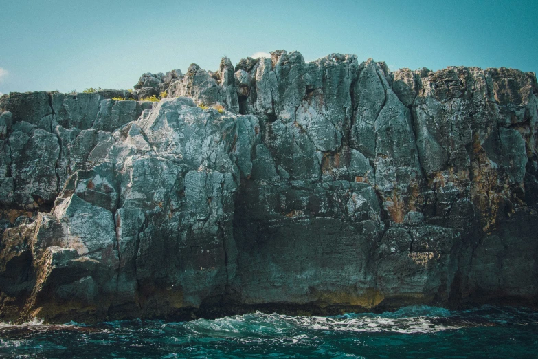 an ocean with cliffs and water at the bottom