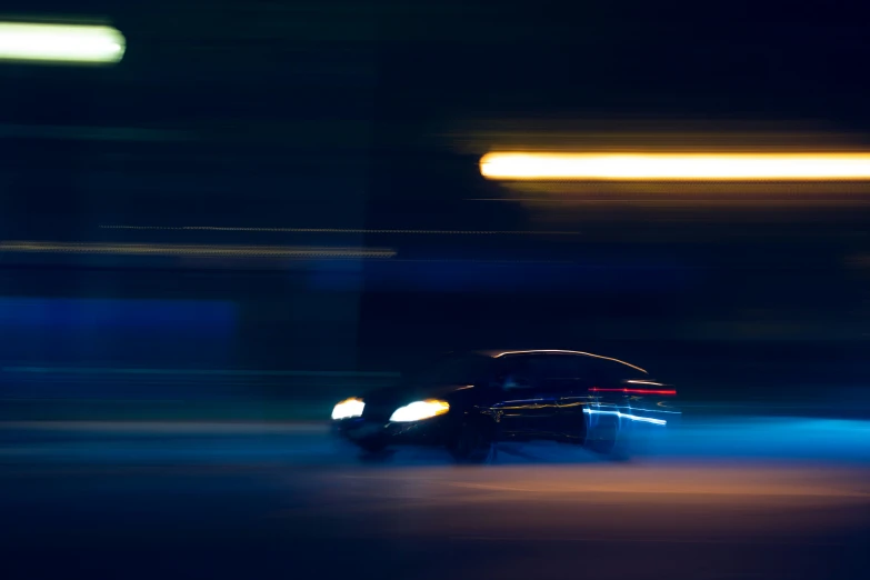 a car traveling through an intersection at night