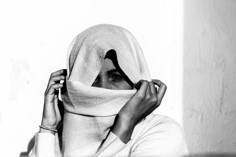 a woman in a hooded hood and a scarf on her head