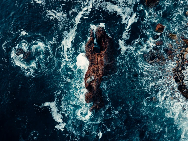 water with rocks and blue sky in the background