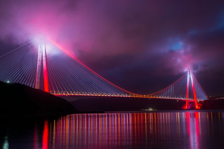 a picture of a bridge illuminated in bright colors