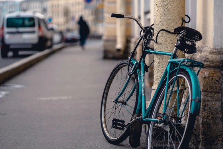 there is a bicycle that is  up to the pole