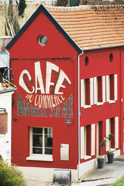 a red building with some graffiti on the side