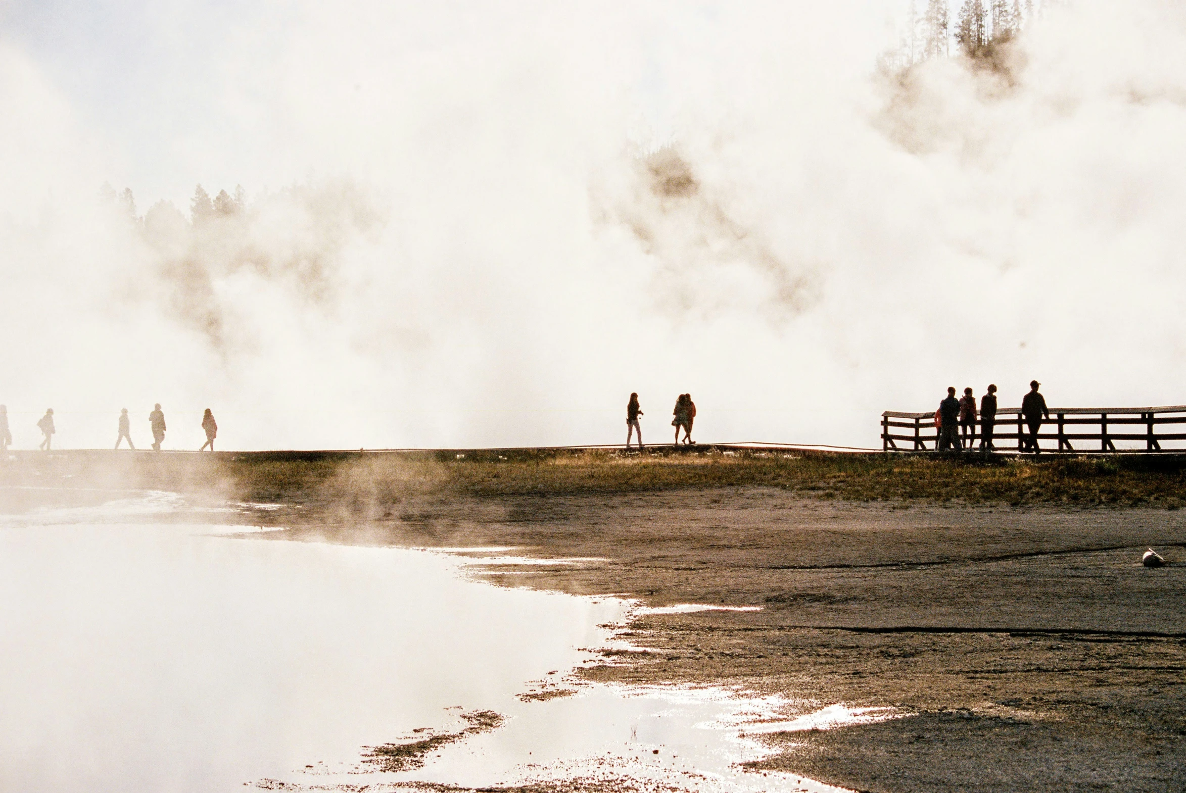 a couple of people standing by the side of the water