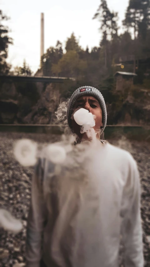 a person blowing a large amount of snow on the face