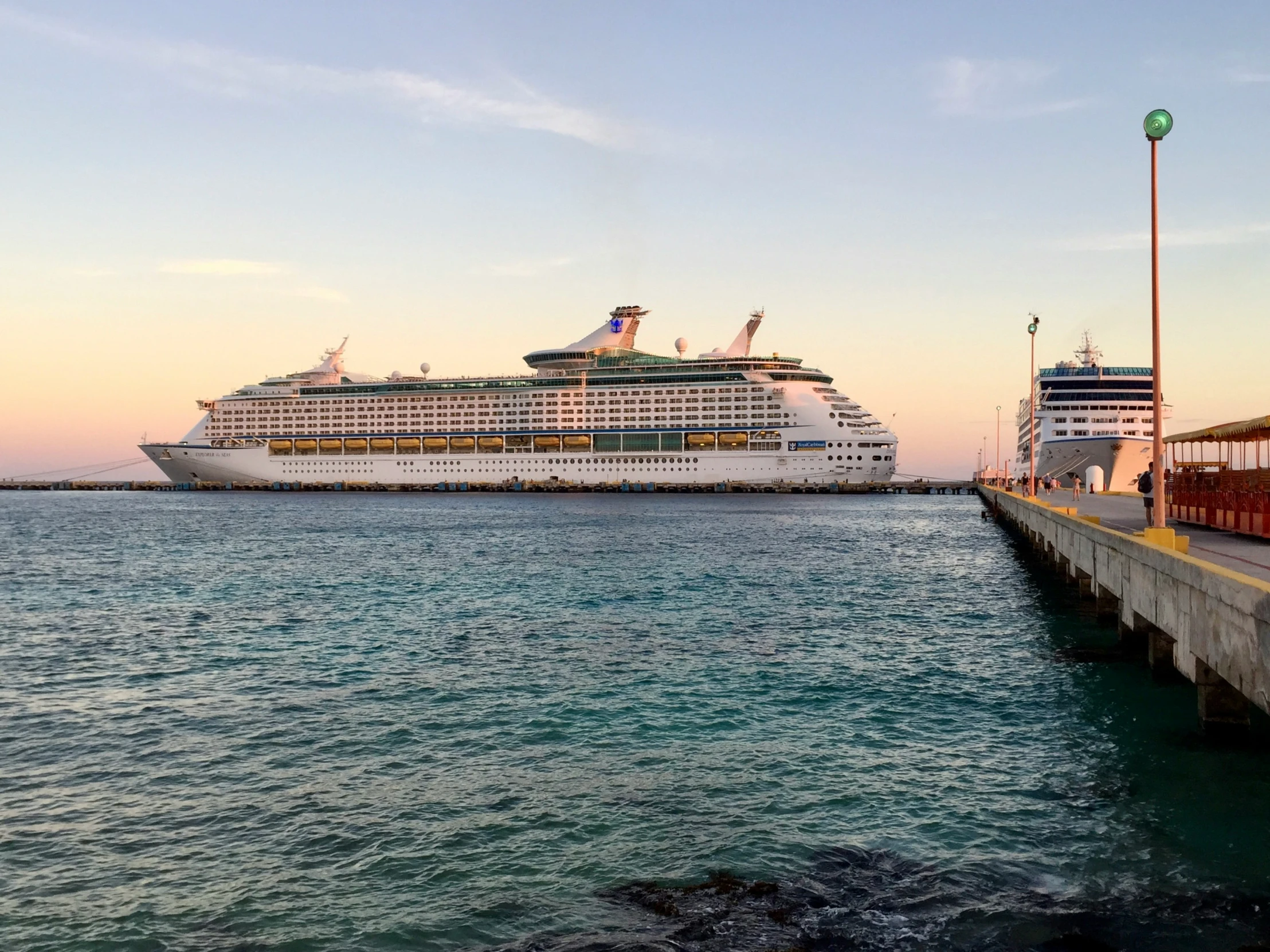 a large ship docked next to another big ship