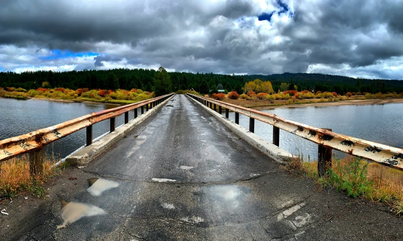 an old bridge stretching into the distance by some water