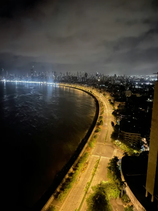 a large body of water at night with a light show in the distance