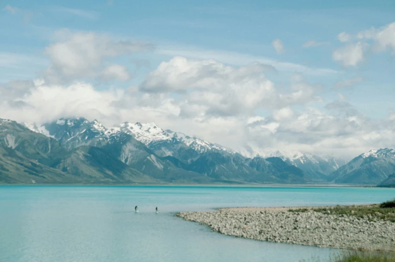 an open expanse with water and mountain range in background