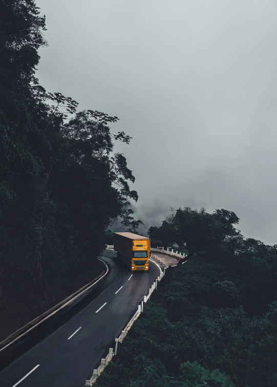 two large buses travel along a winding roadway