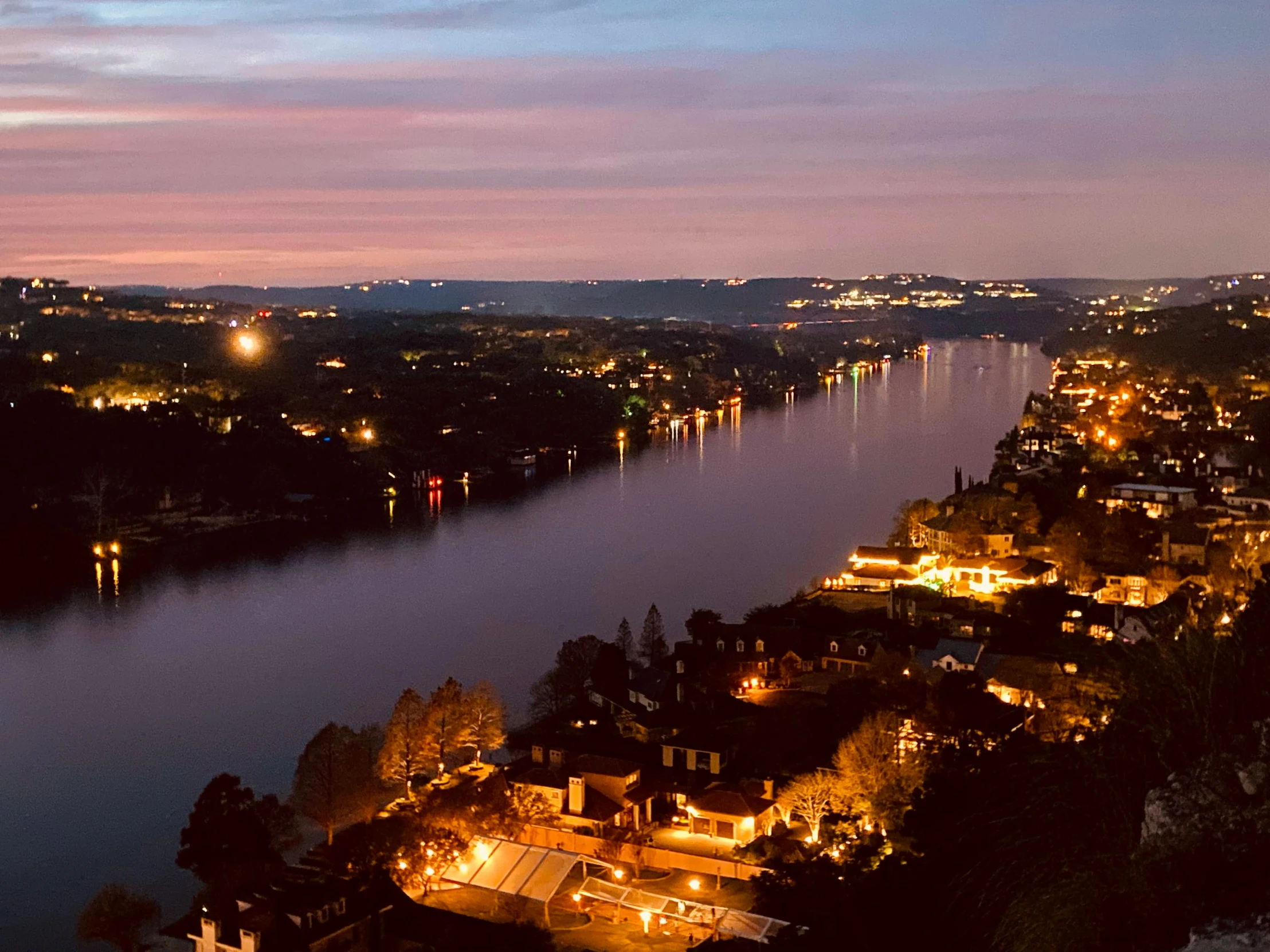 an aerial view of the river, surrounding several town and its surroundings at night