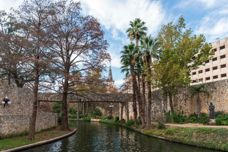 there is a stone bridge that crosses the river