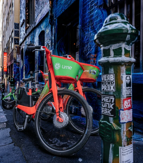 the city street is lined with parked bicycles