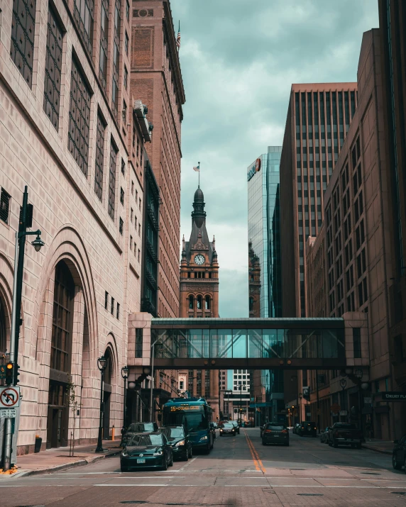 the large clock tower rises above the large city street