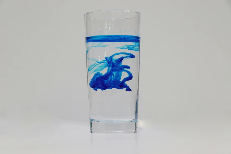 a glass with blue ink in it