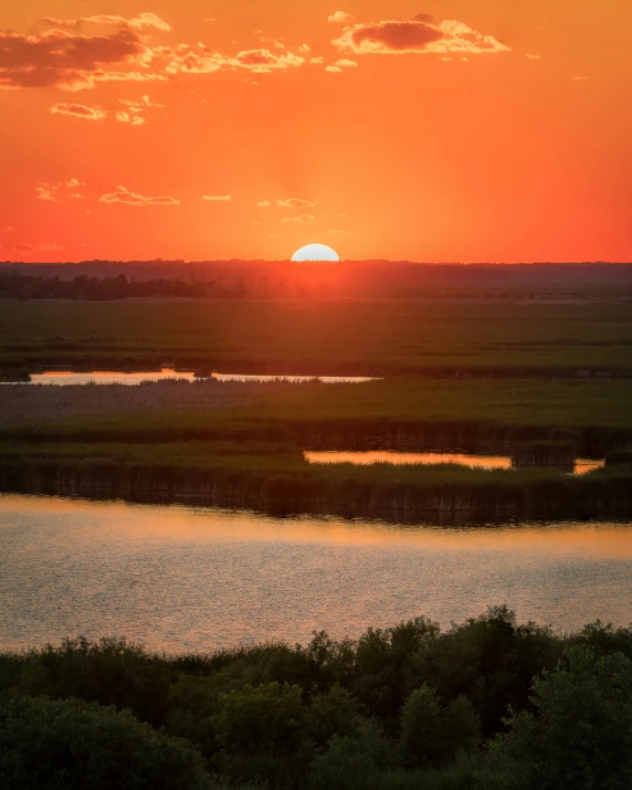 a river with the sun setting over it