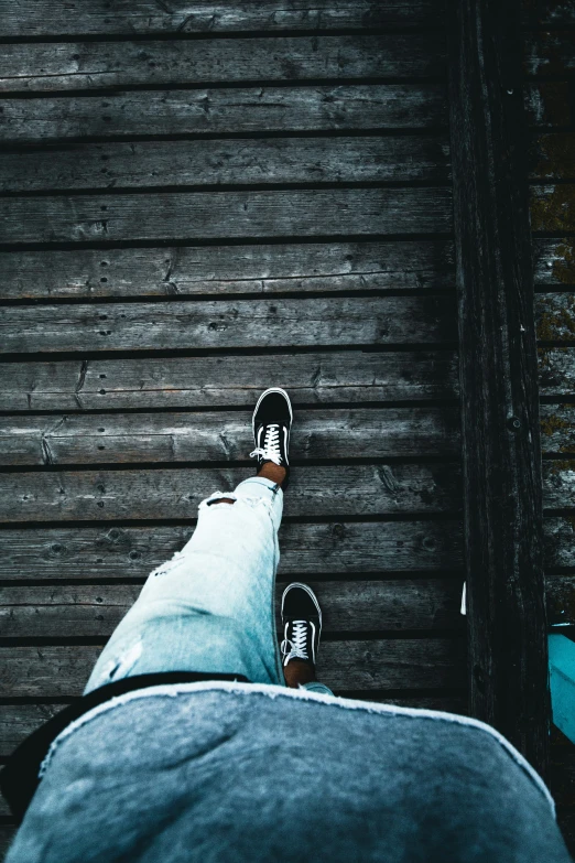 a person standing with their feet up near some wall