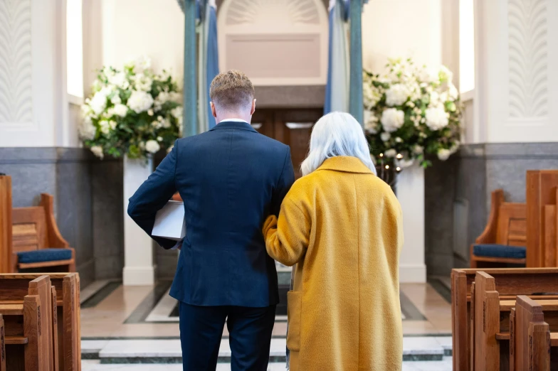 an older couple is standing in front of the alters