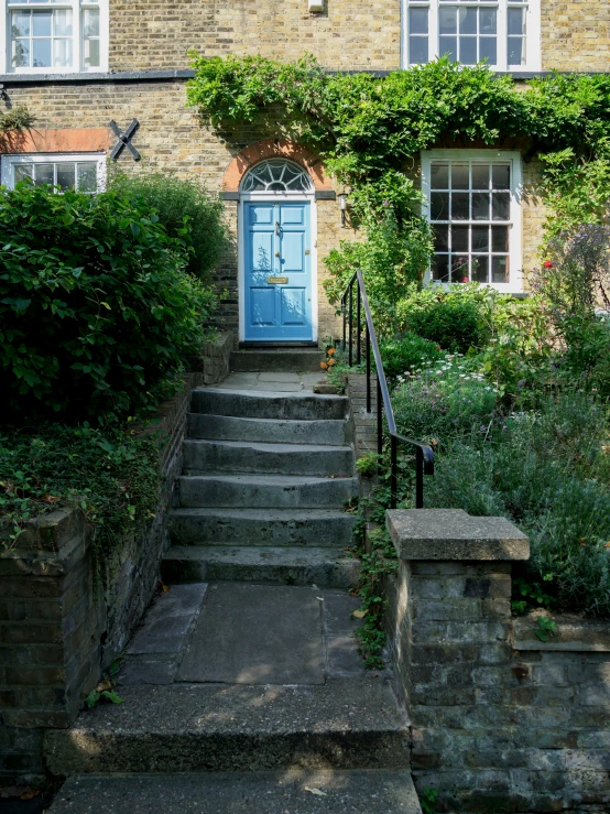 an entrance to a brick house with steps up and down