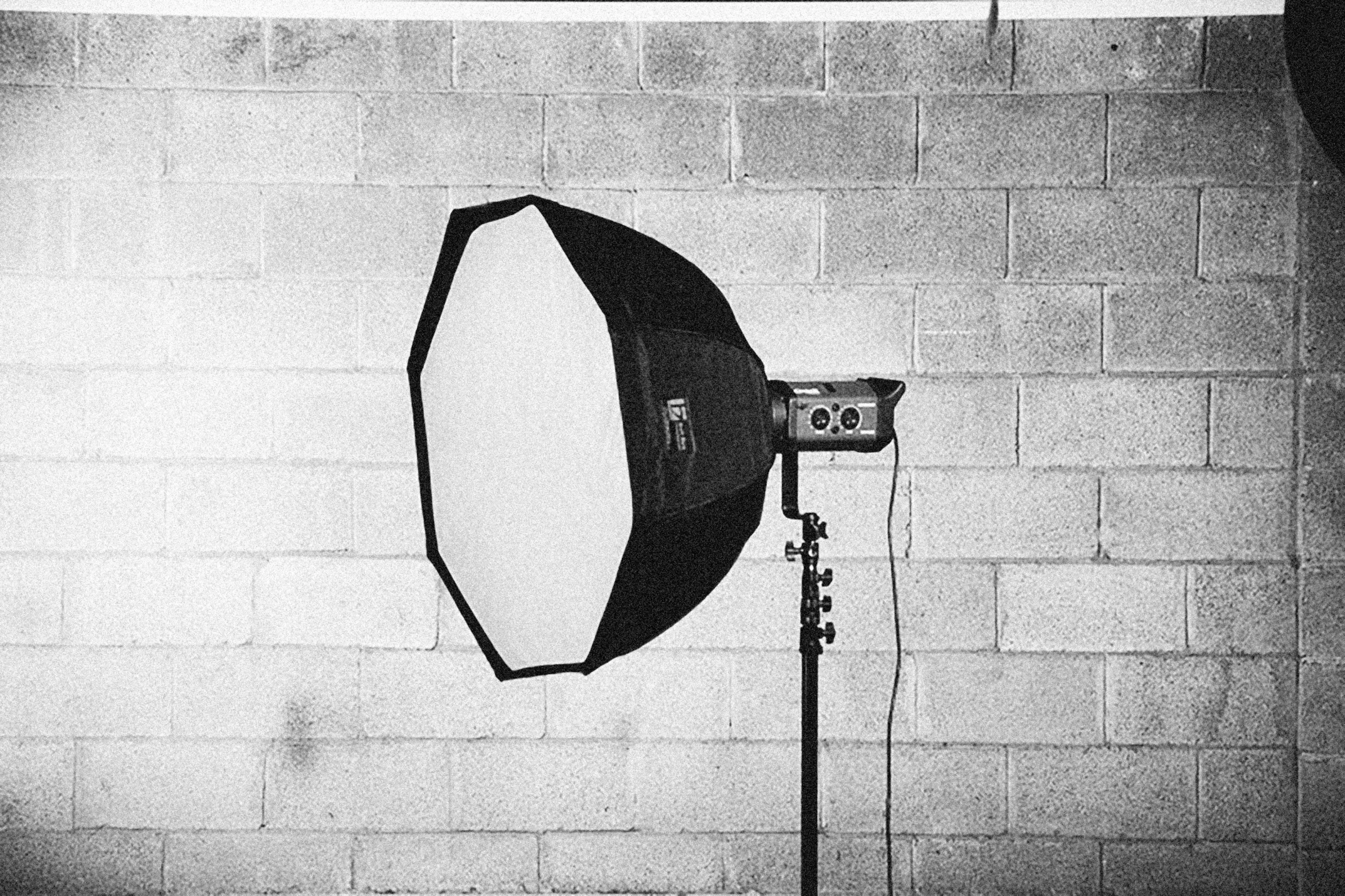 a black and white po of a light on a tripod