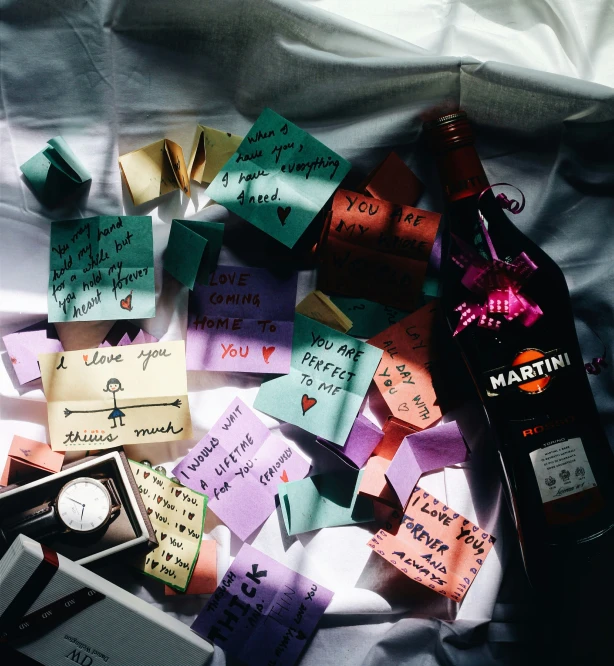 a bottle of alcohol is surrounded by notes and other small items