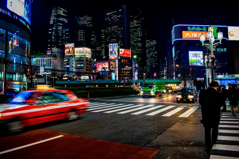 the city lights are shining brightly over the buildings and cars