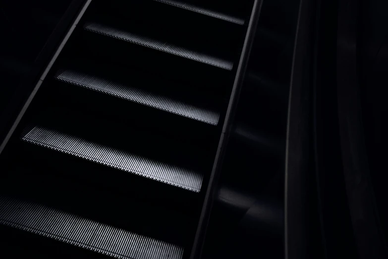 a set of black steps in a dark building