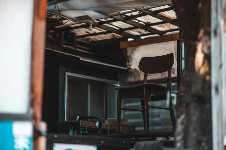 a wooden chair sitting next to a metal door