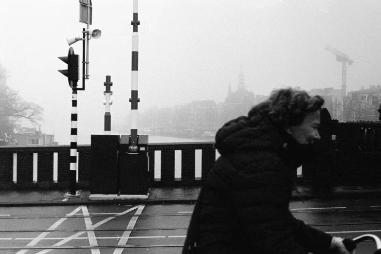 a lady walking down a street in the rain