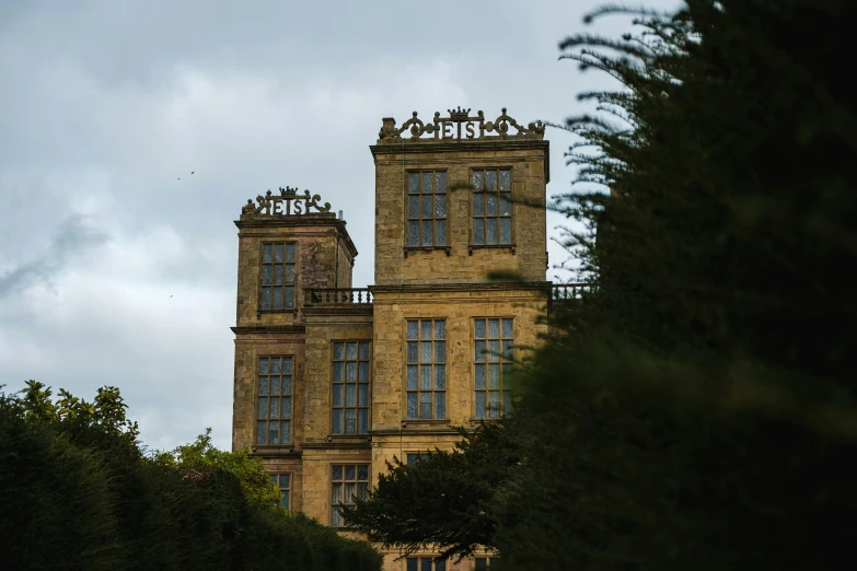 two tall buildings with clocks and sky in the background