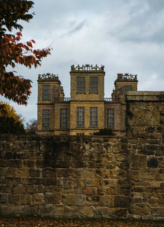 a stone wall with two large towers on it