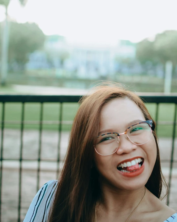 a woman in glasses smiling at the camera