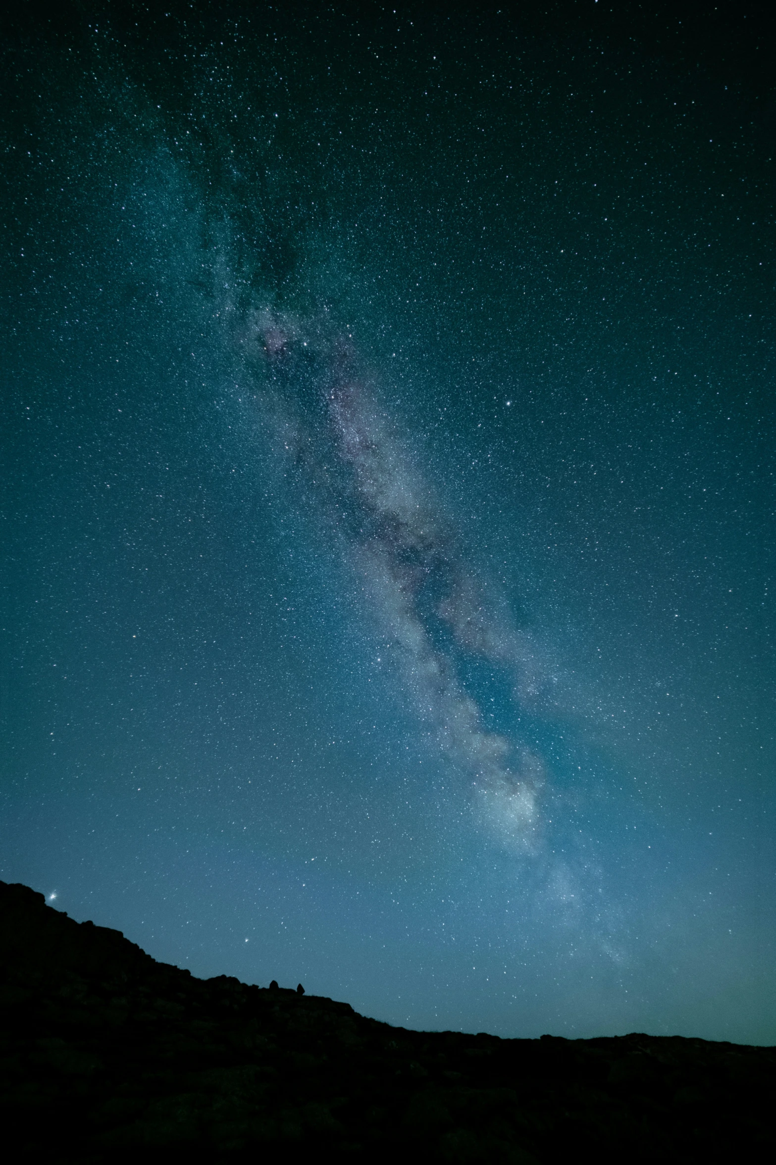 the milky rising above the mountain side at night