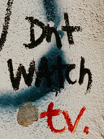 a sign reads eat watch on the ground