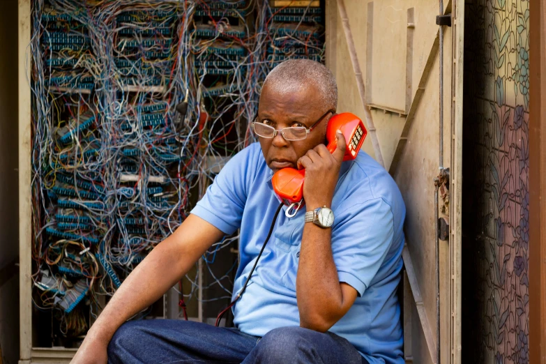 a man in sunglasses and glasses talking on a phone