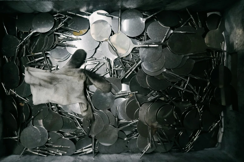 a large pile of silverware in a box