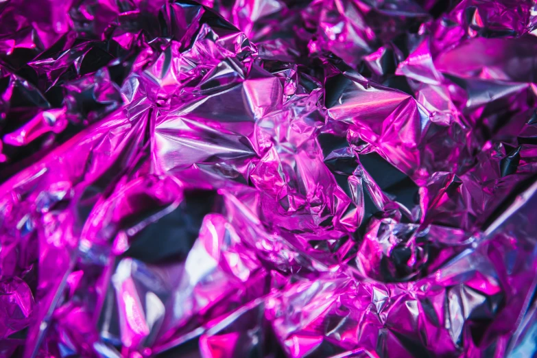 a purple background is full of shiny and colorful rocks