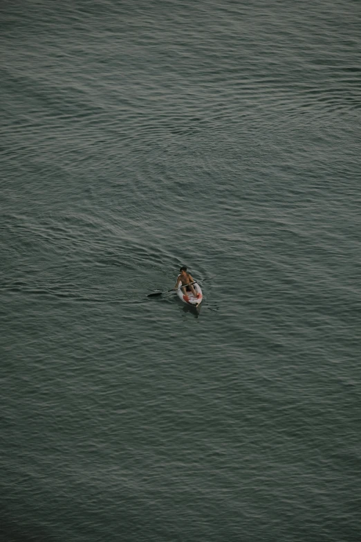 a person in the water on a boogie board