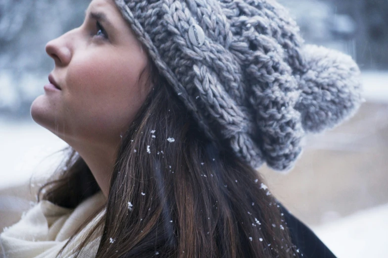 woman wearing knit hat in snowy park setting