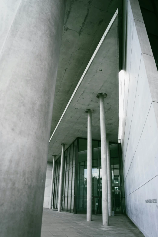 an empty room with three columns and two doors