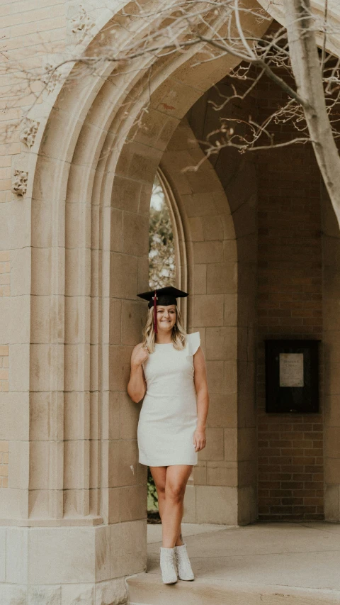 a woman wearing a graduation hat is posing for the camera