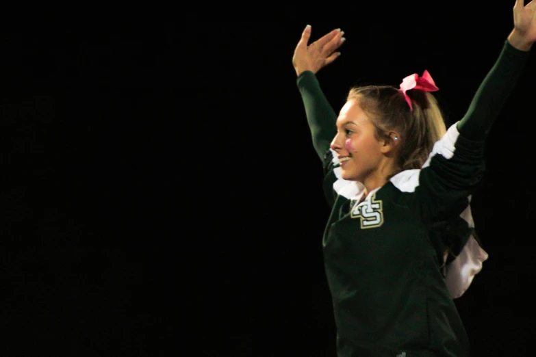 a young female is holding her hands up