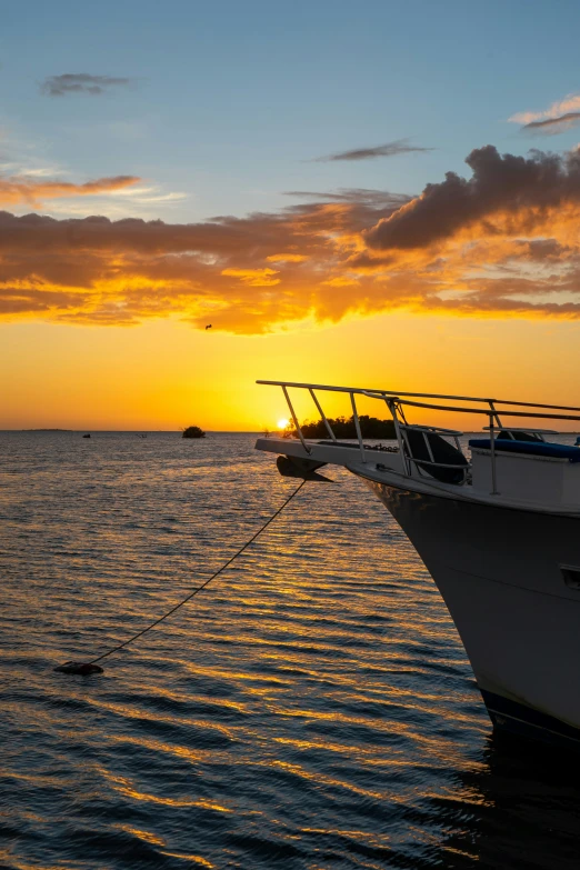 a boat in a body of water during sunset