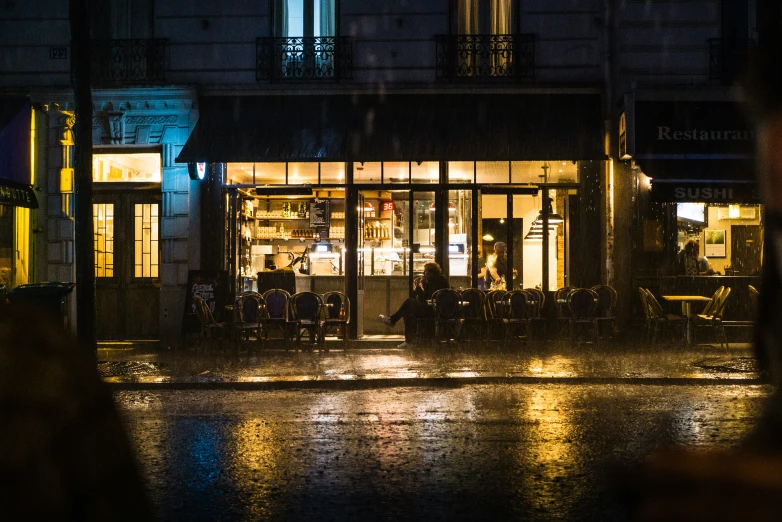 a lit up cafe building next to a street