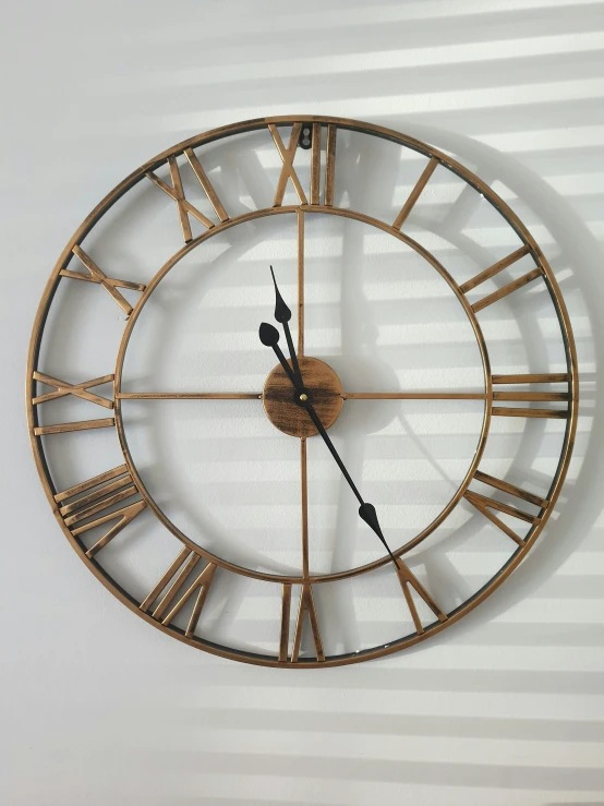 an unusual clock with metal handles and roman numerals