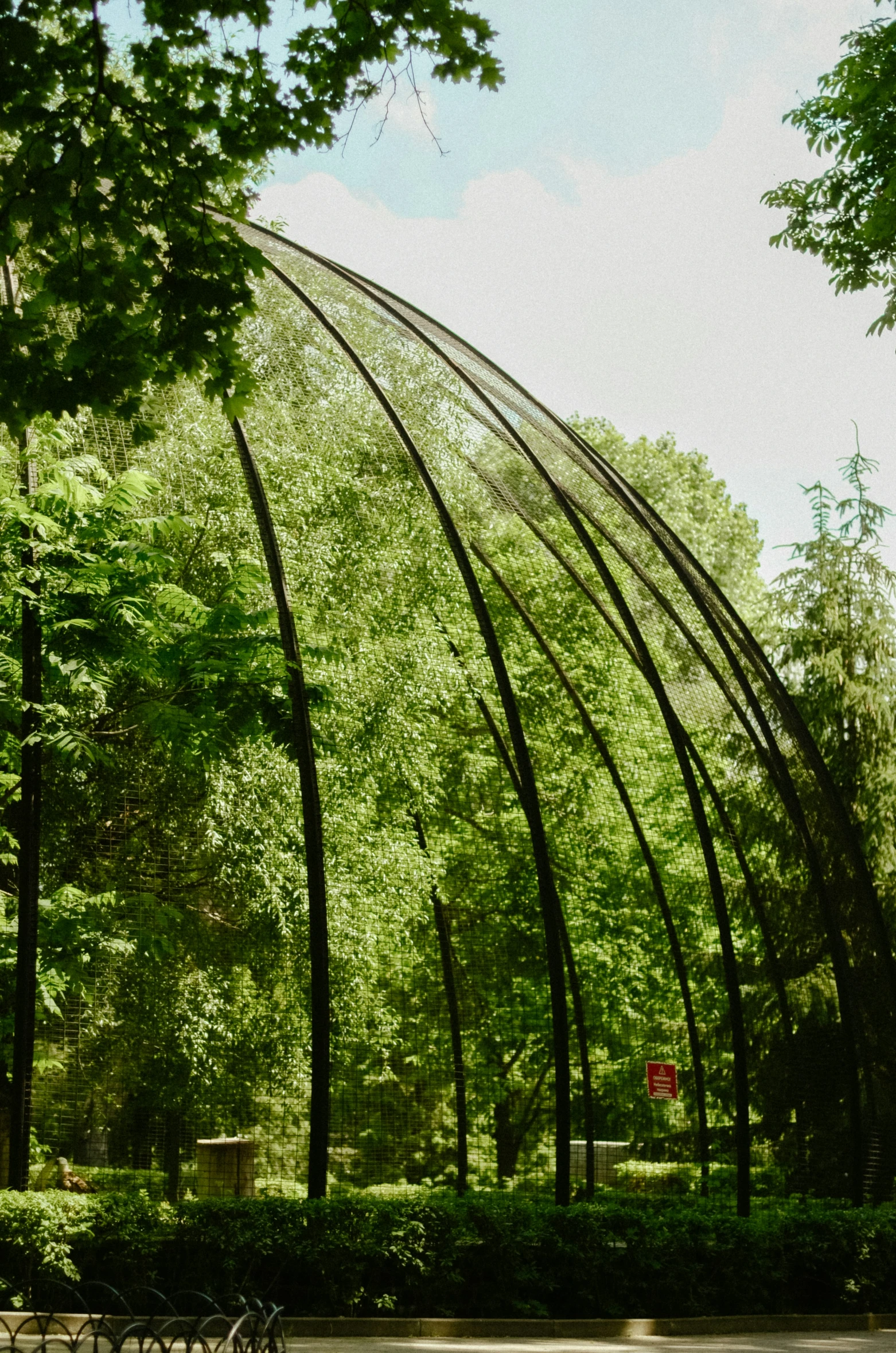 this is a park with a curved metal structure and benches